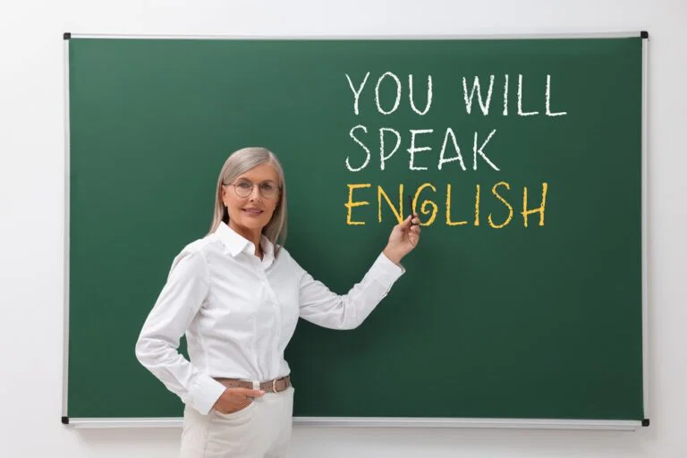 teacher,pointing,at,text,you,will,speak,english,on,green